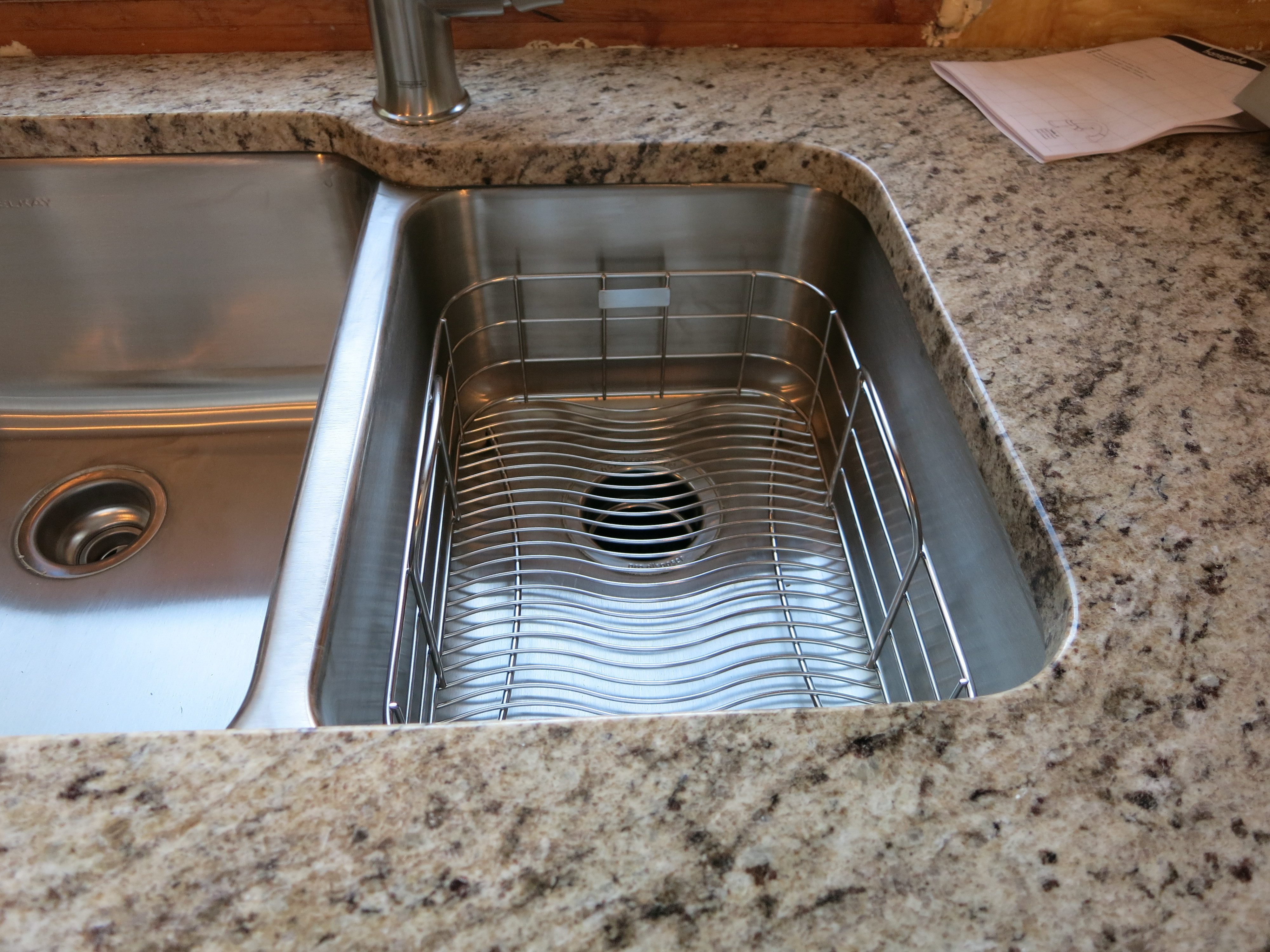 Stainless steel in-sink colander.